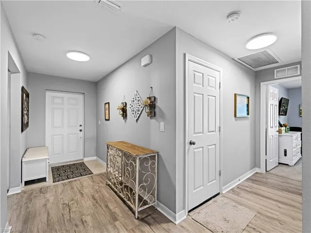 Entrance foyer featuring light wood-style floors