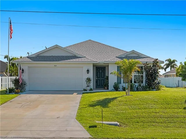 Ranch-style home with stucco siding, a shingled roof, driveway, and an attached garage