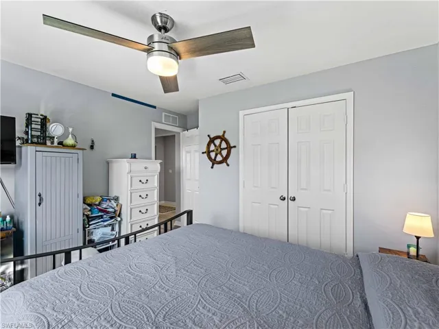 Bedroom featuring ceiling fan and a closet