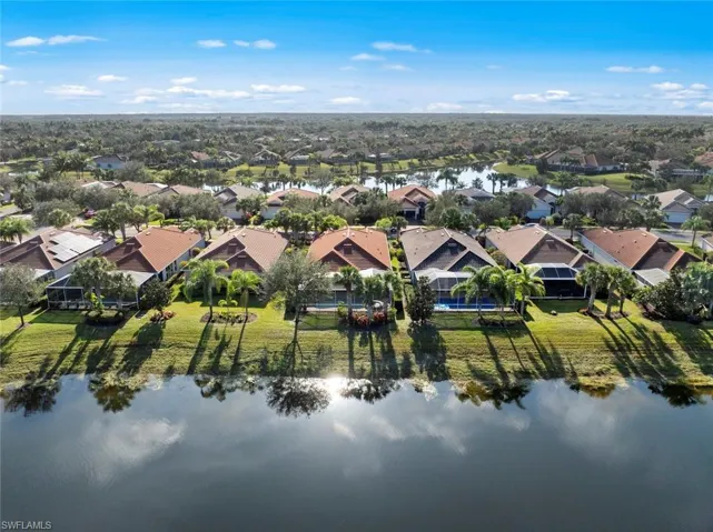 Aerial perspective of suburban area featuring a large body of water