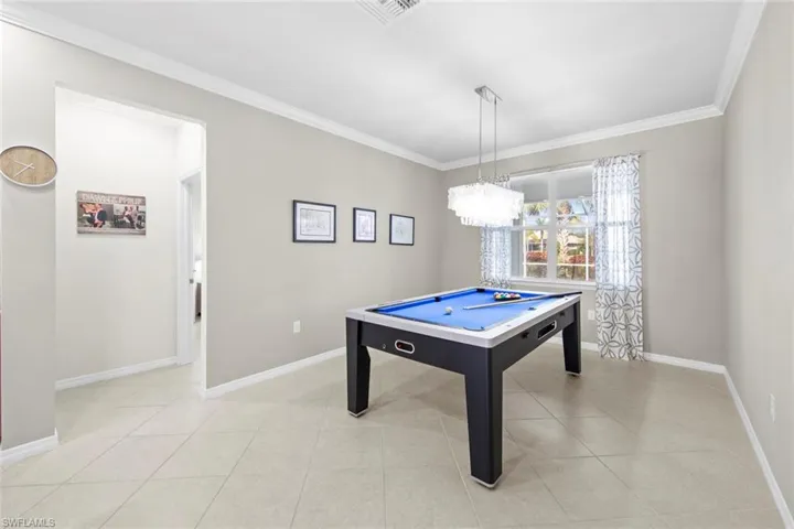 Game room with crown molding, light tile patterned flooring, and pool table