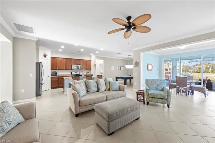 Living room featuring ornamental molding, light tile patterned floors, billiards, a ceiling fan, and recessed lighting