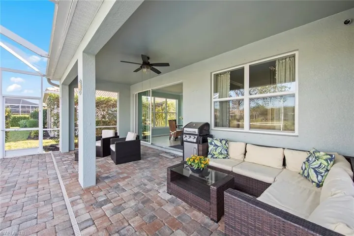 View of patio with an outdoor living space, a sunroom, a lanai, and a ceiling fan