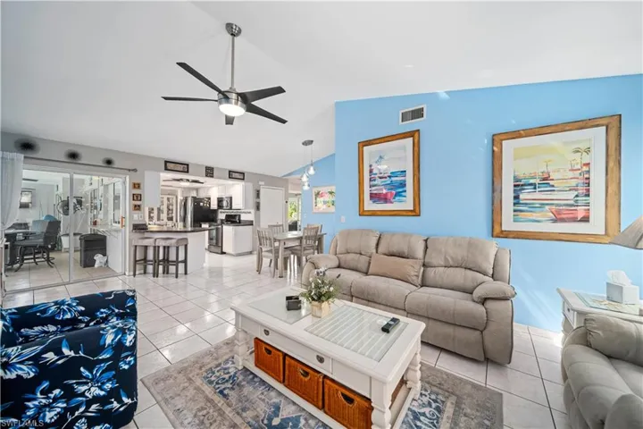 Tiled family room with tile floors and vaulted ceilings