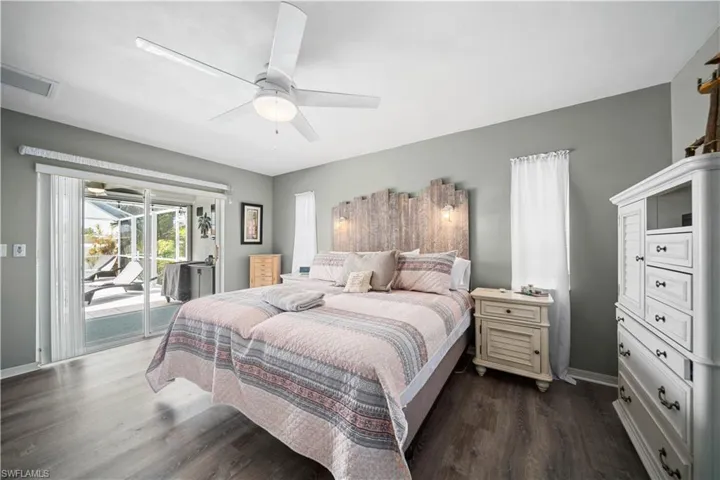 Primary Bedroom with tiled plank flooring and view of the pool
