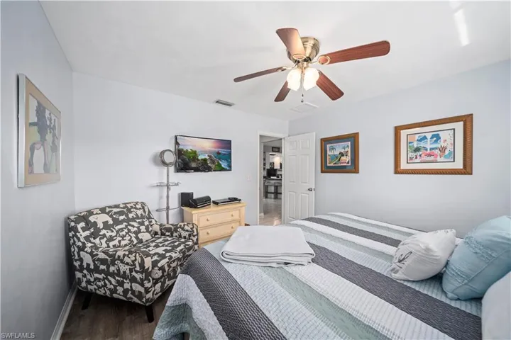 Bedroom featuring ceiling fan and dark wood-style floors