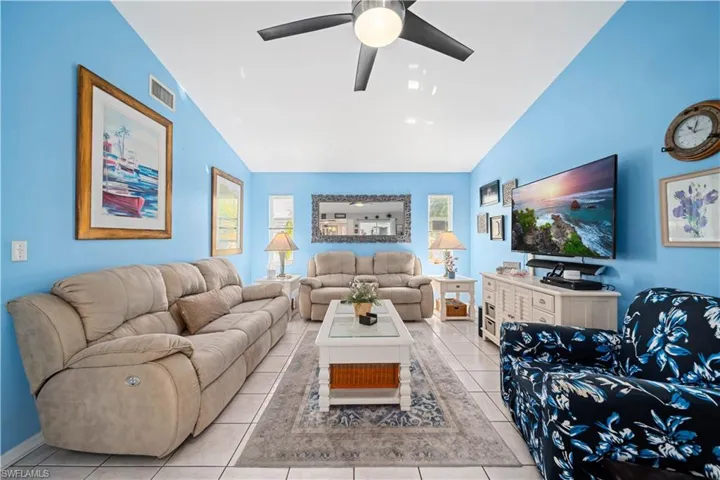 Tiled family room with tile floors and vaulted ceilings