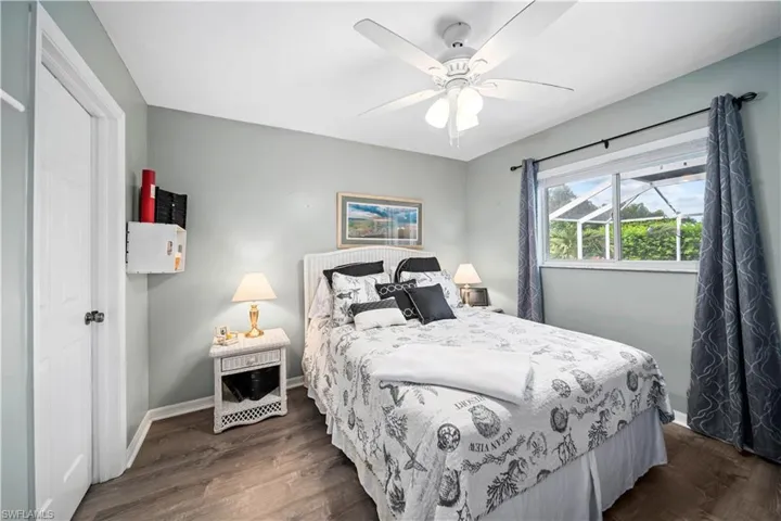 Bedroom with ceiling fan and wood-style tiled flooring
