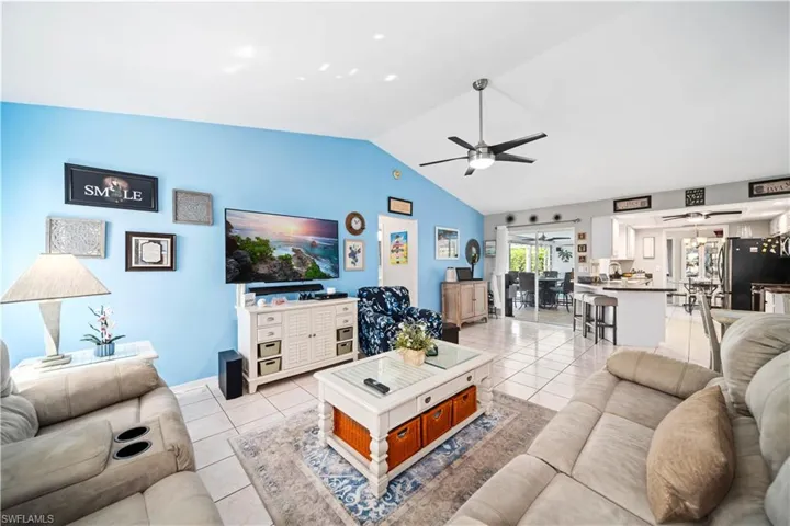 Tiled family room with tile floors and vaulted ceilings