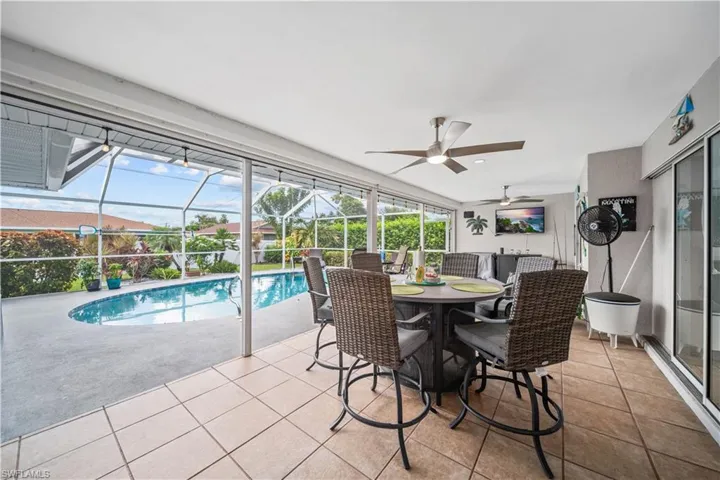 Large under truss lanai with electric impact screening overlooking pool