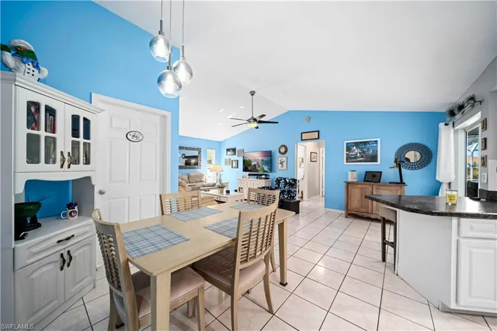 Tiled dining area with vaulted ceilings