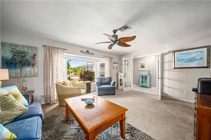 Living area with view to the outdoors and French doors to entryway