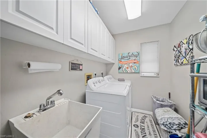 Laundry room with abundant cabinets & utility sink