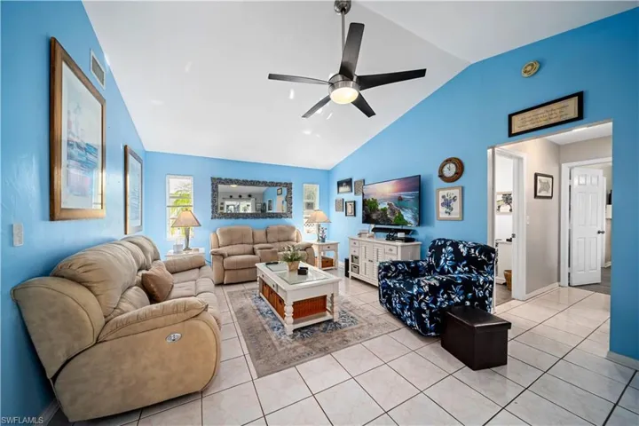 Large family room with tile floors and vaulted ceilings