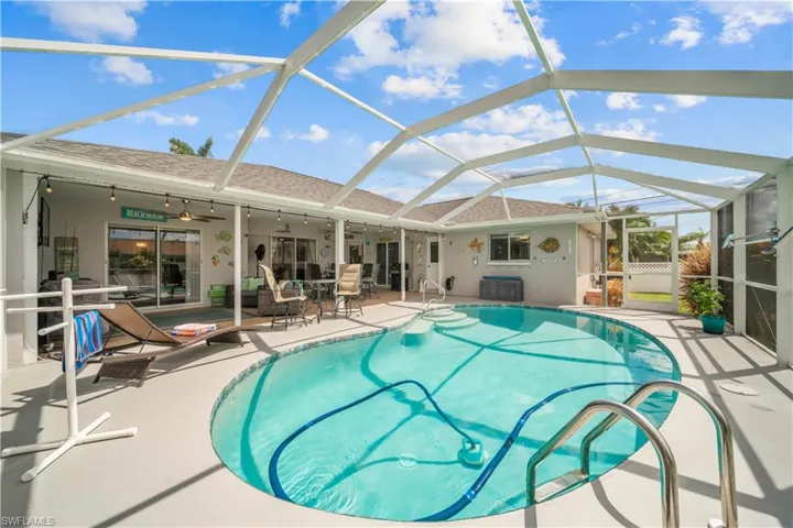 View of pool featuring a lanai, ceiling fan, and a patio