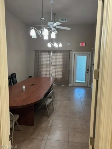 Dining room featuring light tile patterned floors and ceiling fan