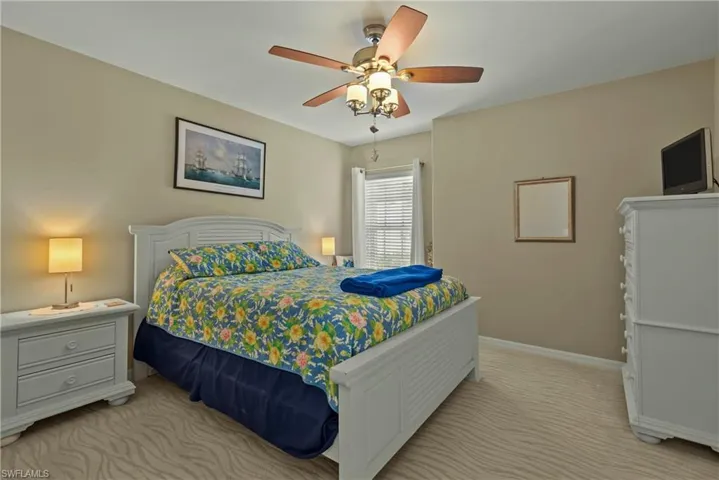 Bedroom featuring a ceiling fan and light carpet