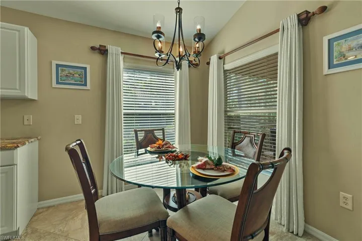 Breakfast Nook with plenty of natural light, lofted ceiling, and a chandelier
