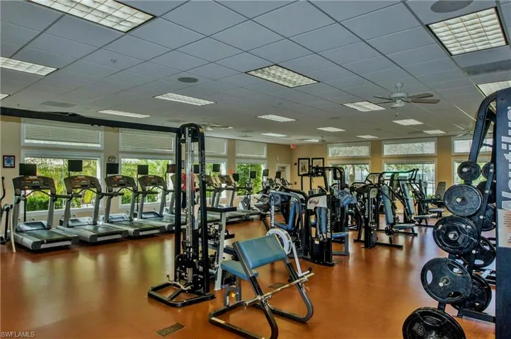 Exercise room with a drop ceiling and a ceiling fan