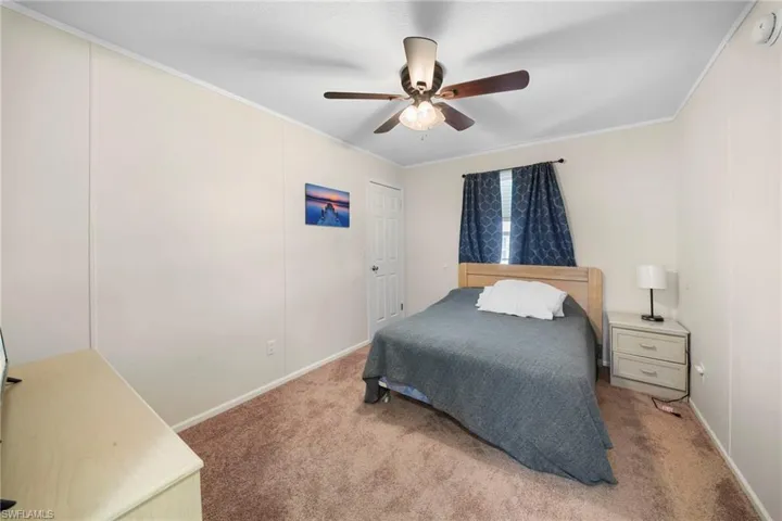 Neutral-toned walls complement the brown carpeted flooring