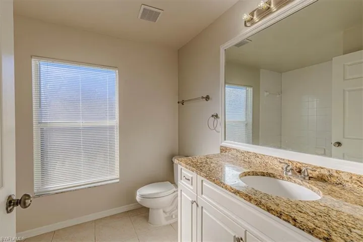 Bathroom featuring vanity, a shower, and light tile patterned floors