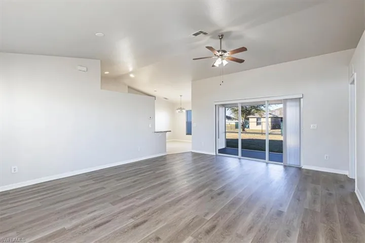 Spare room with vaulted ceiling, wood finished floors, ceiling fan, and recessed lighting
