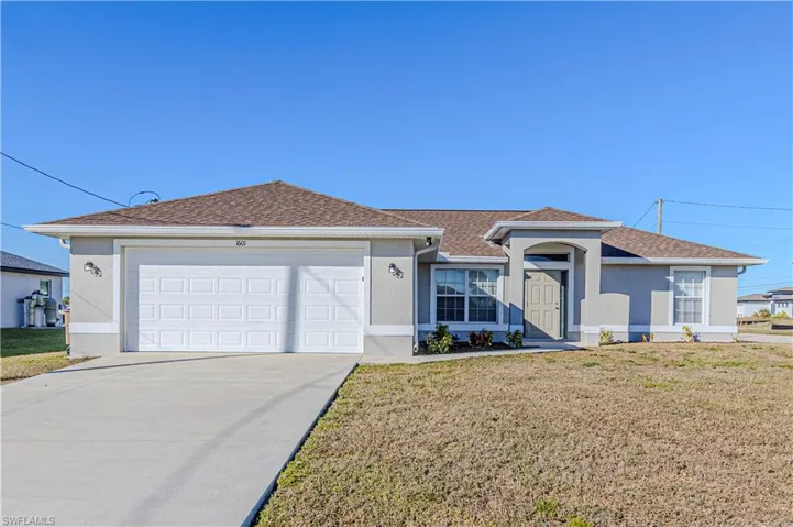 Single story home featuring stucco siding, a front yard, driveway, and roof with shingles