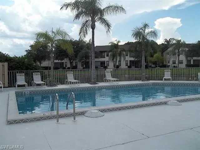 Community pool with a patio