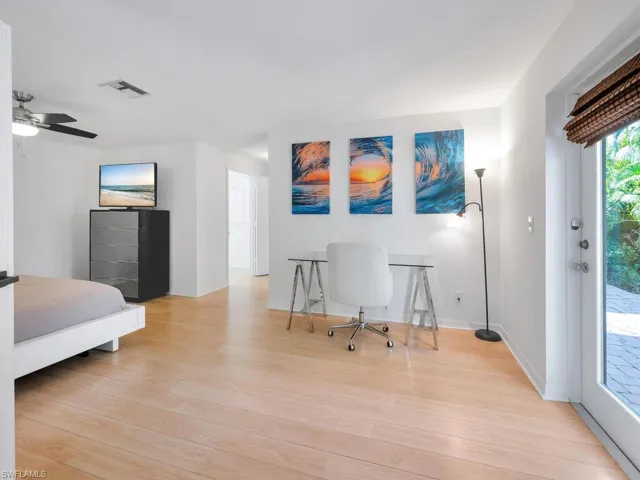 Bedroom with ceiling fan, light hardwood / wood-style floors, and access to exterior