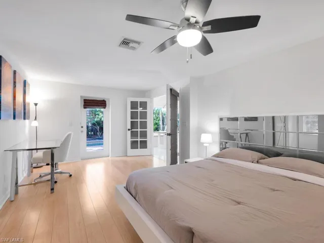 Bedroom featuring access to outside, light hardwood / wood-style flooring, and ceiling fan
