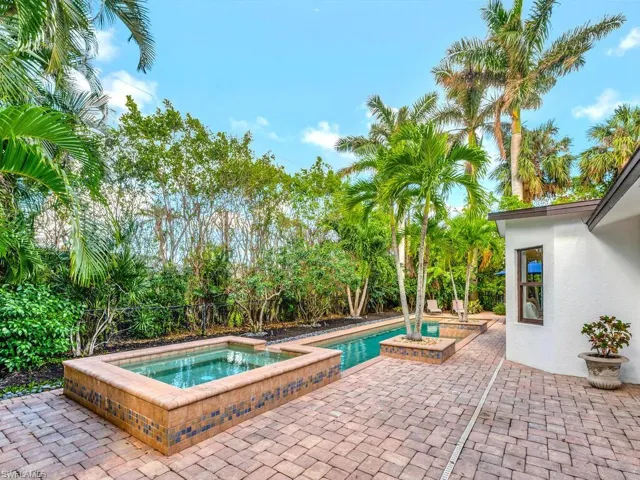 View of swimming pool with a patio area and an in ground hot tub