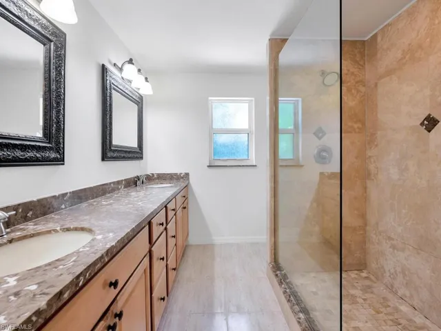 Bathroom with vanity and a tile shower