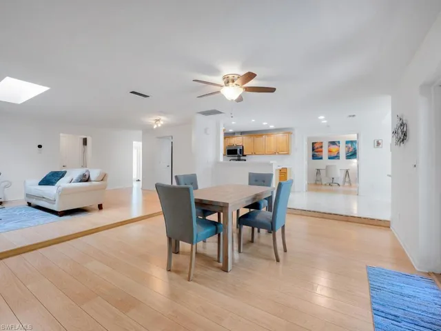 Dining area featuring light wood-type flooring and ceiling fan