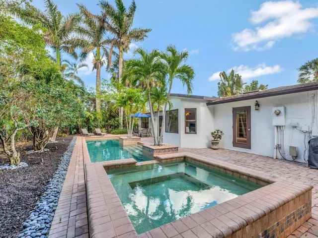 View of pool featuring a patio and an in ground hot tub