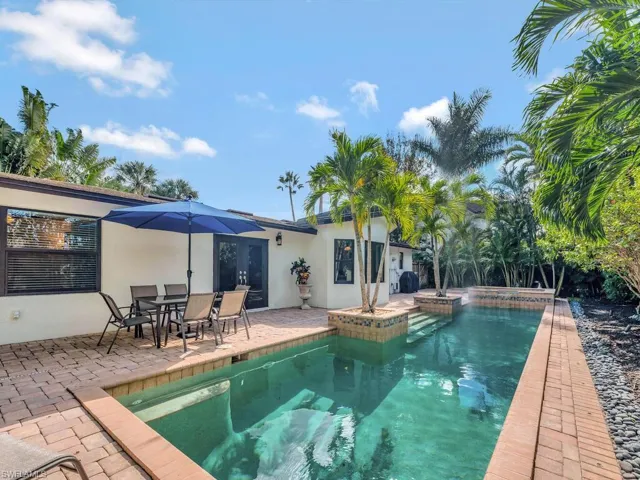 View of swimming pool featuring a patio and an in ground hot tub