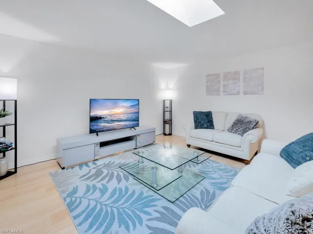 Living room with light hardwood / wood-style floors