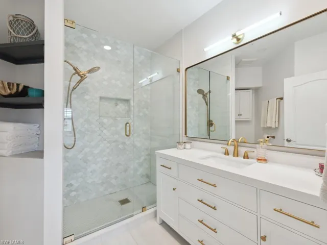 Just Renovated Primary Bath with tile flooring, vanity, and an enclosed shower/Toto commode/