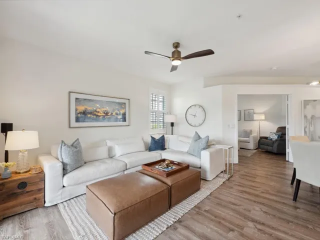Great room with ceiling fan and wood-style flooring