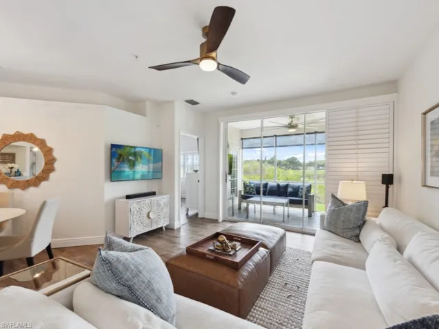 Great room with wood-style flooring and ceiling fan