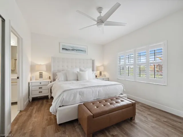 Primary Bedroom featuring ceiling fan, wood-style floors