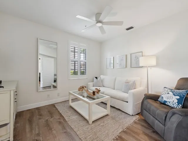 Den featuring ceiling fan and wood-style floors -Perfect for additional Guests with sleeper sofa