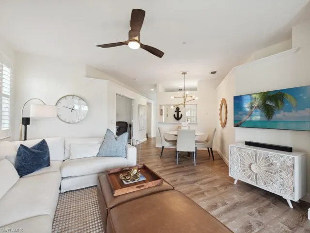 Great room featuring ceiling fan with custom chandelier and wood -style flooring