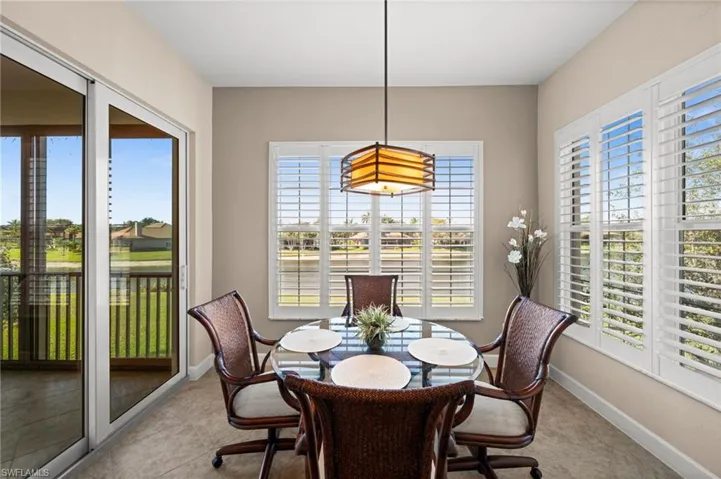 Dinette with beautiful views bright with light streaming in from slider and windows, windows have new planation shutters!