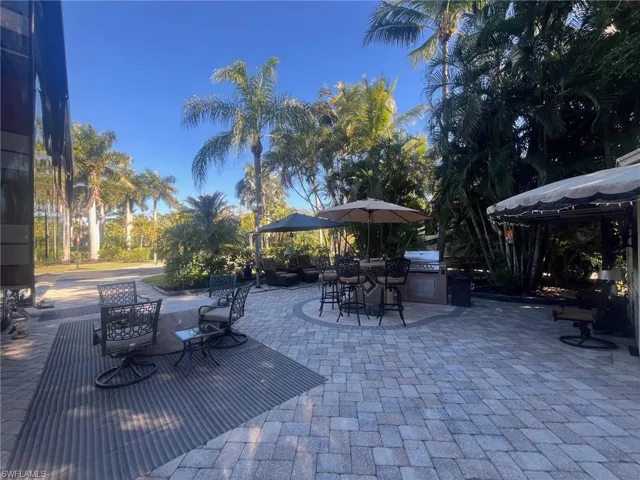 View of patio with area for grilling and outdoor dining space
