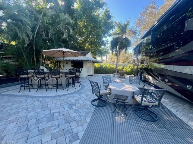 View of patio / terrace with outdoor dining area and an outdoor kitchen