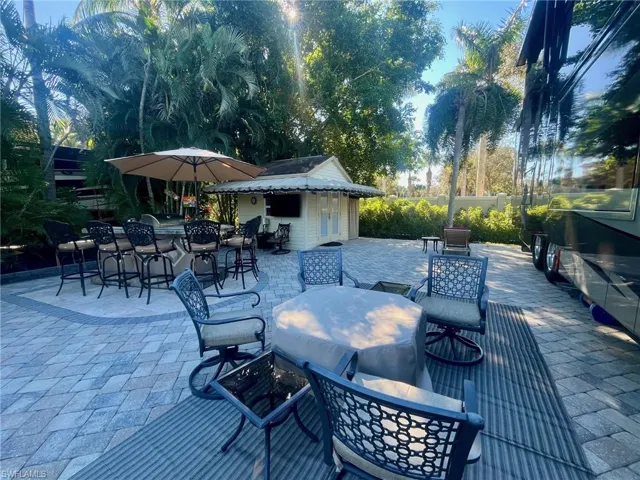 View of patio / terrace featuring outdoor dining area and an outbuilding