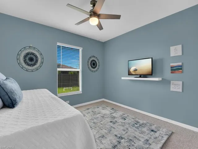 Bedroom with carpet flooring and a ceiling fan