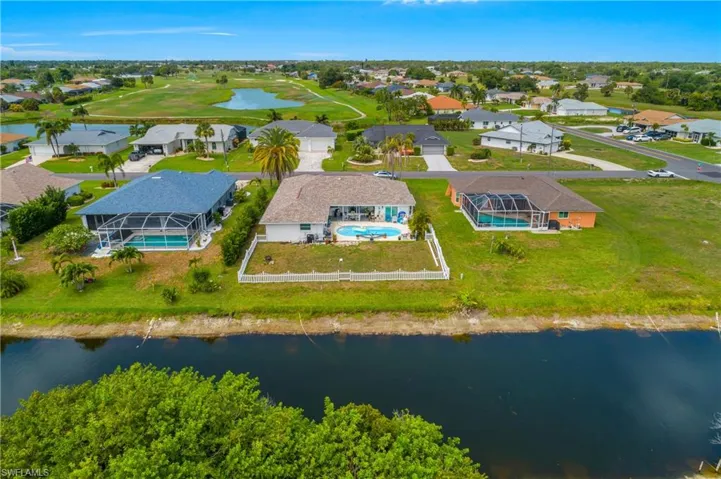 fenced in yard with beautiful canal views