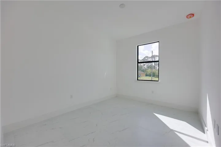 Spare room with baseboards and light marble finish flooring