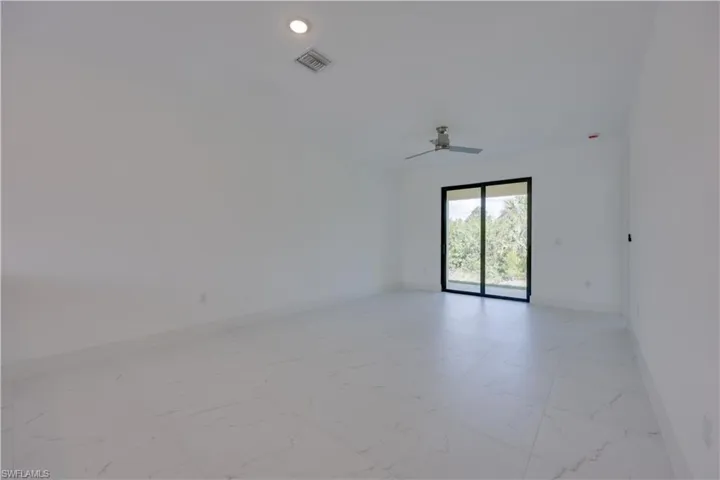 Spare room with light marble finish flooring, ceiling fan, and recessed lighting